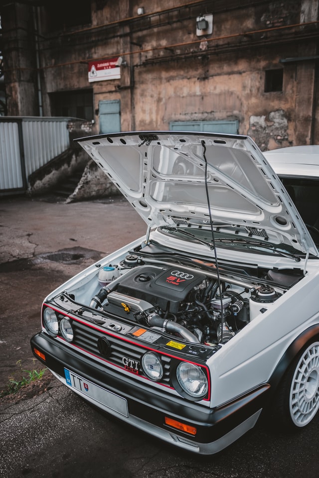 Photo of a white tuned Volkswagen Golf MK II with open hood